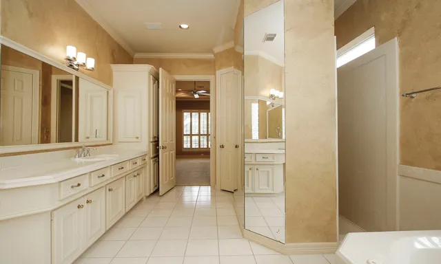 a bathroom with a glass door shower a sink and a mirror