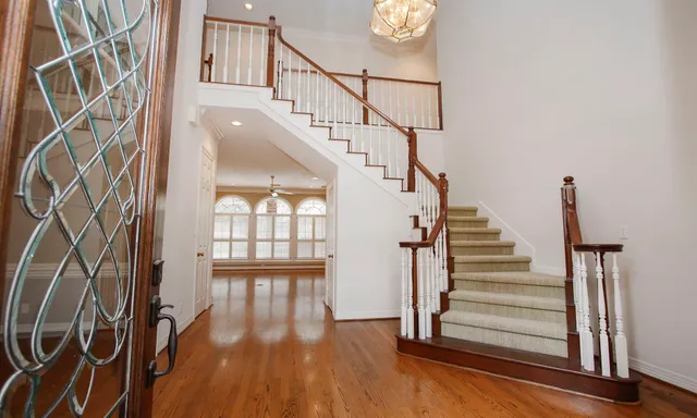 a view of entryway and hall with wooden floor