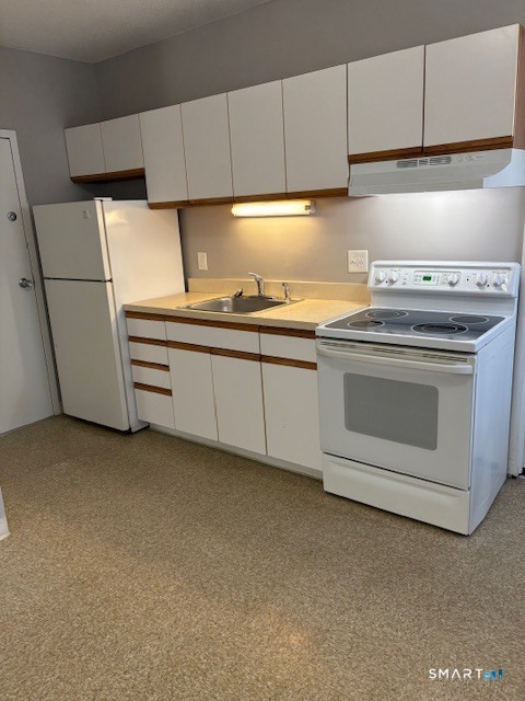a kitchen with cabinets and appliances