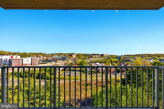 a view of a tall building next to a road