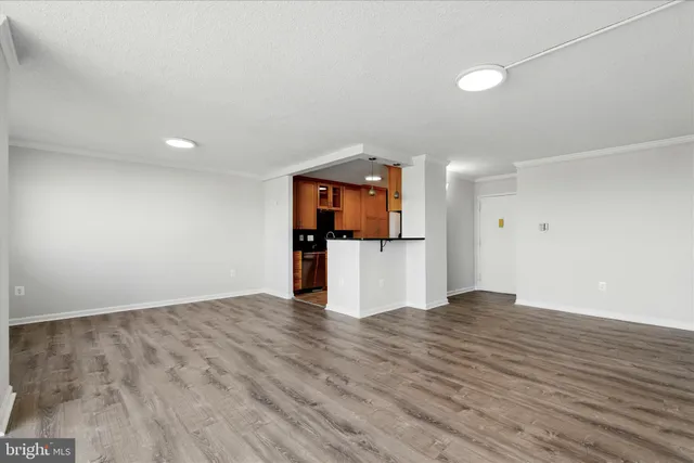 a view of a kitchen with a sink and a refrigerator