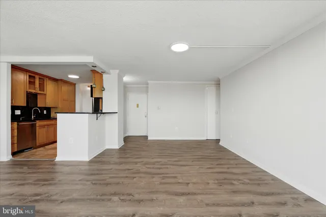 a view of kitchen view with wooden floor and stainless steel appliances