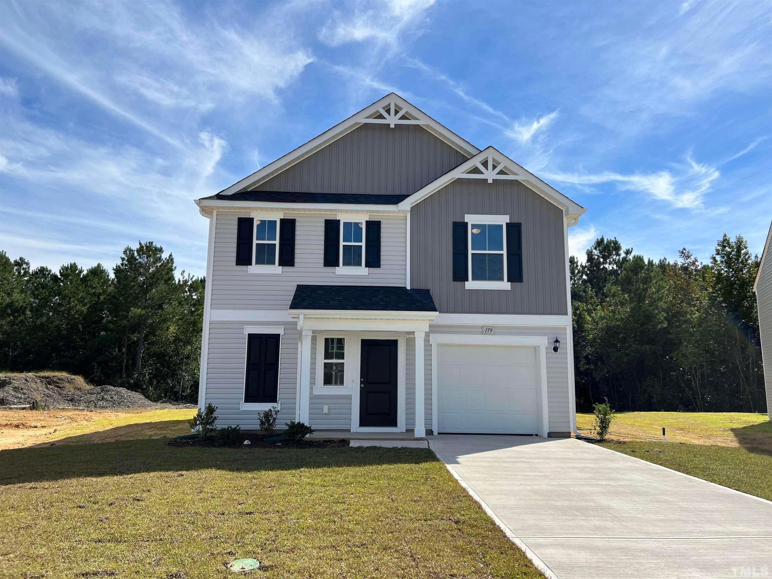 179 Maple Tree Lane Clayton, NC 27527 - Photo 1 of 18 a front view of a house with a yard