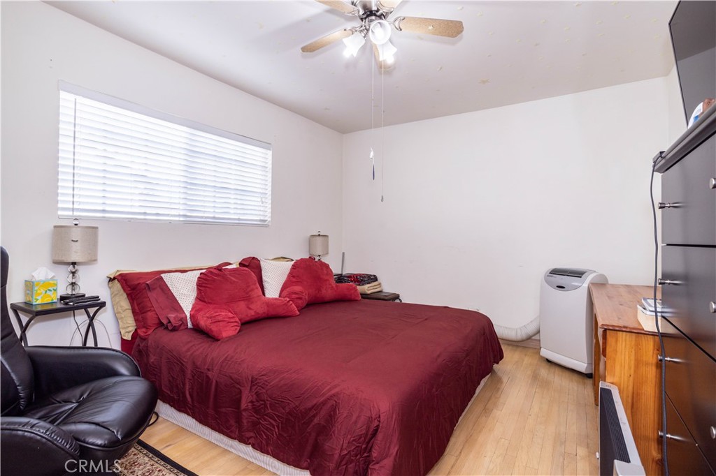 7414 Quartz Avenue Winnetka, CA 91306 - Photo 12 of 42 a bedroom with a bed and a chandelier