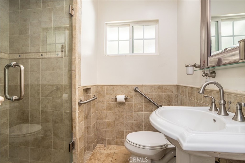 7414 Quartz Avenue Winnetka, CA 91306 - Photo 15 of 42 a bathroom with a sink a toilet and a shower