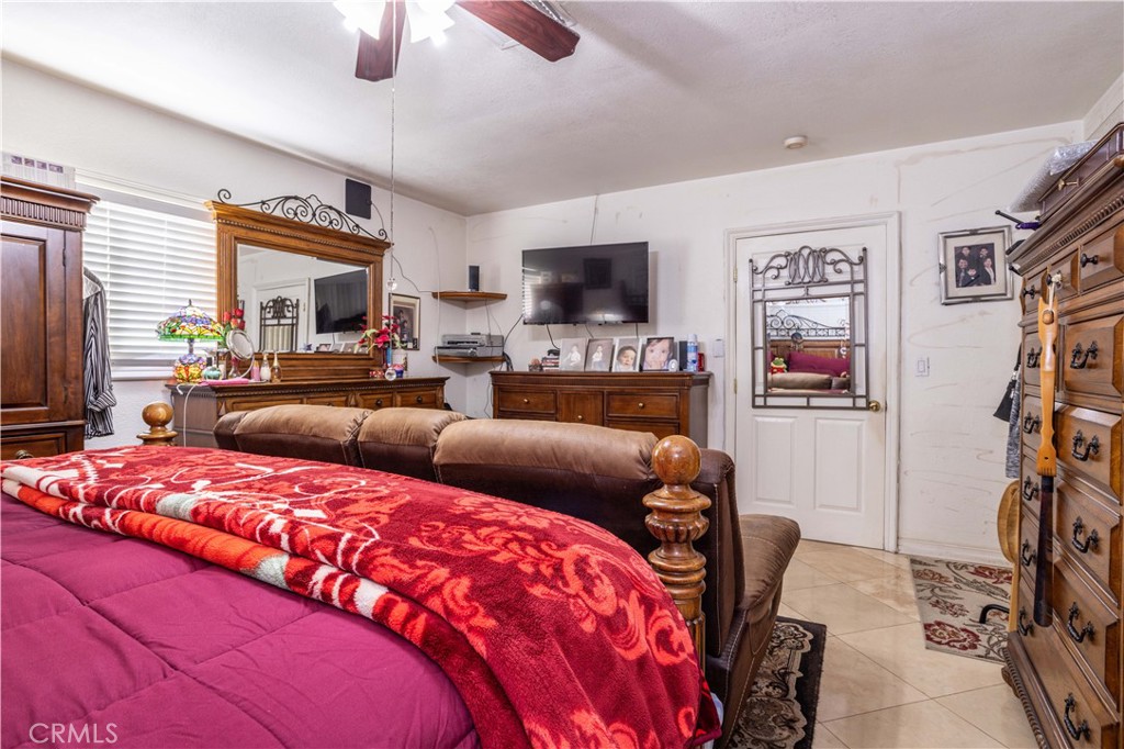 7414 Quartz Avenue Winnetka, CA 91306 - Photo 16 of 42 a bedroom with a bed a couch and dresser