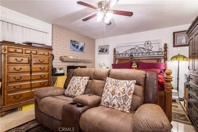 a living room with furniture and a ceiling fan