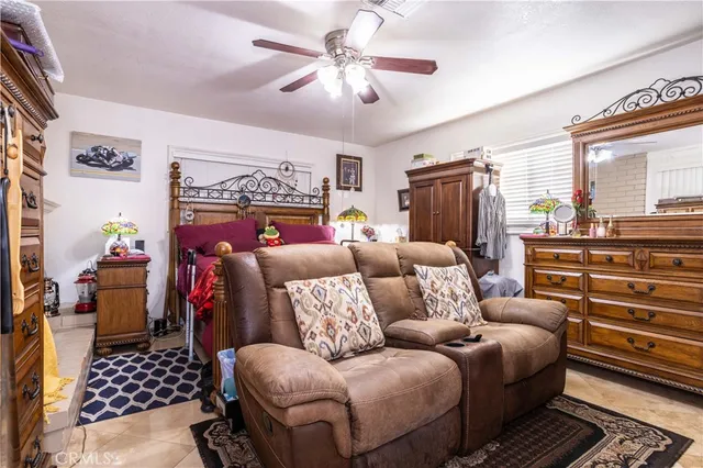 a living room with furniture a fireplace and a chandelier