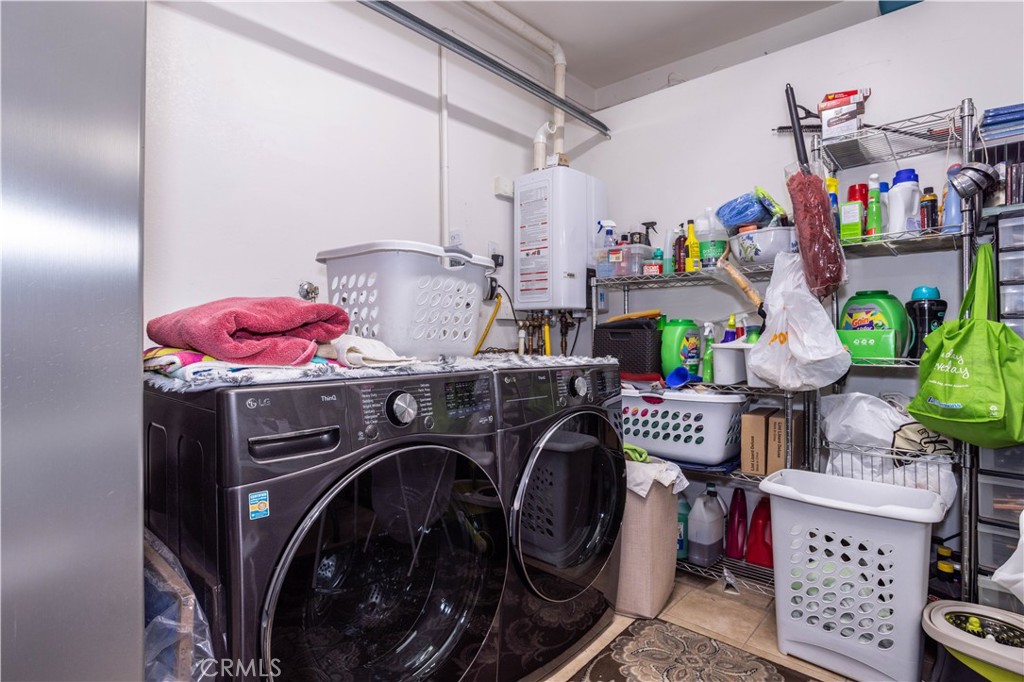 7414 Quartz Avenue Winnetka, CA 91306 - Photo 25 of 42 a utility room with dryer washer and a view of living room
