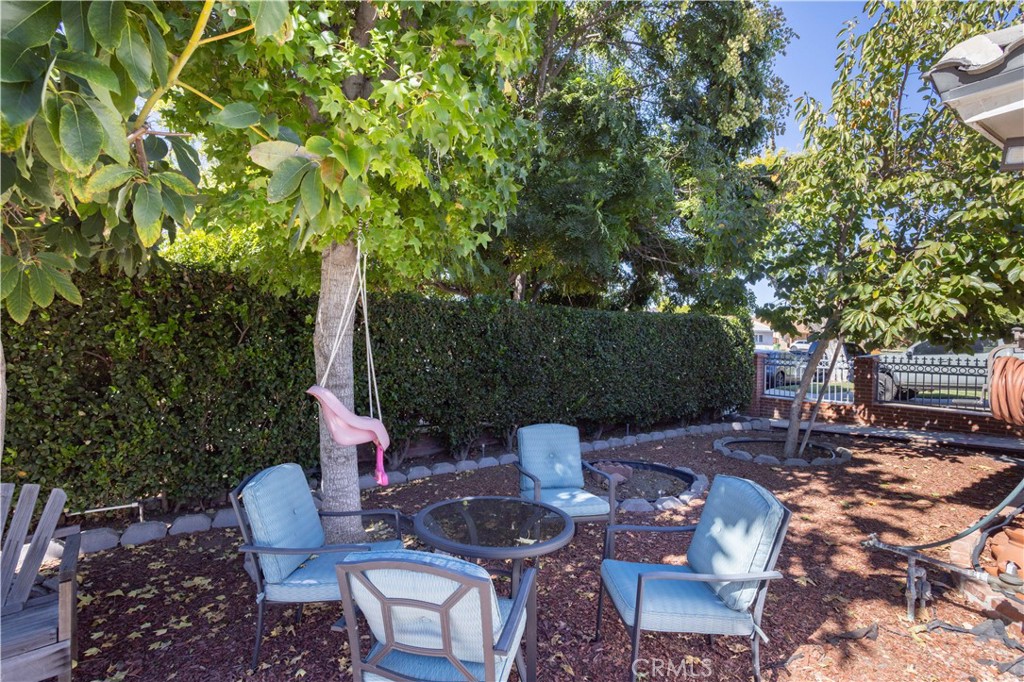 7414 Quartz Avenue Winnetka, CA 91306 - Photo 34 of 42 a backyard of a house with fountain table and chairs
