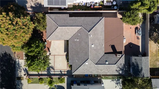 an aerial view of a house with a yard