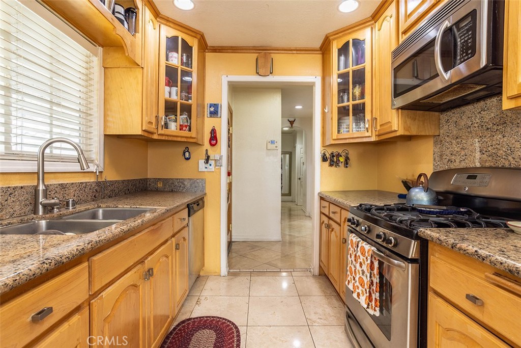 7414 Quartz Avenue Winnetka, CA 91306 - Photo 8 of 42 a kitchen with stainless steel appliances granite countertop a stove and a sink
