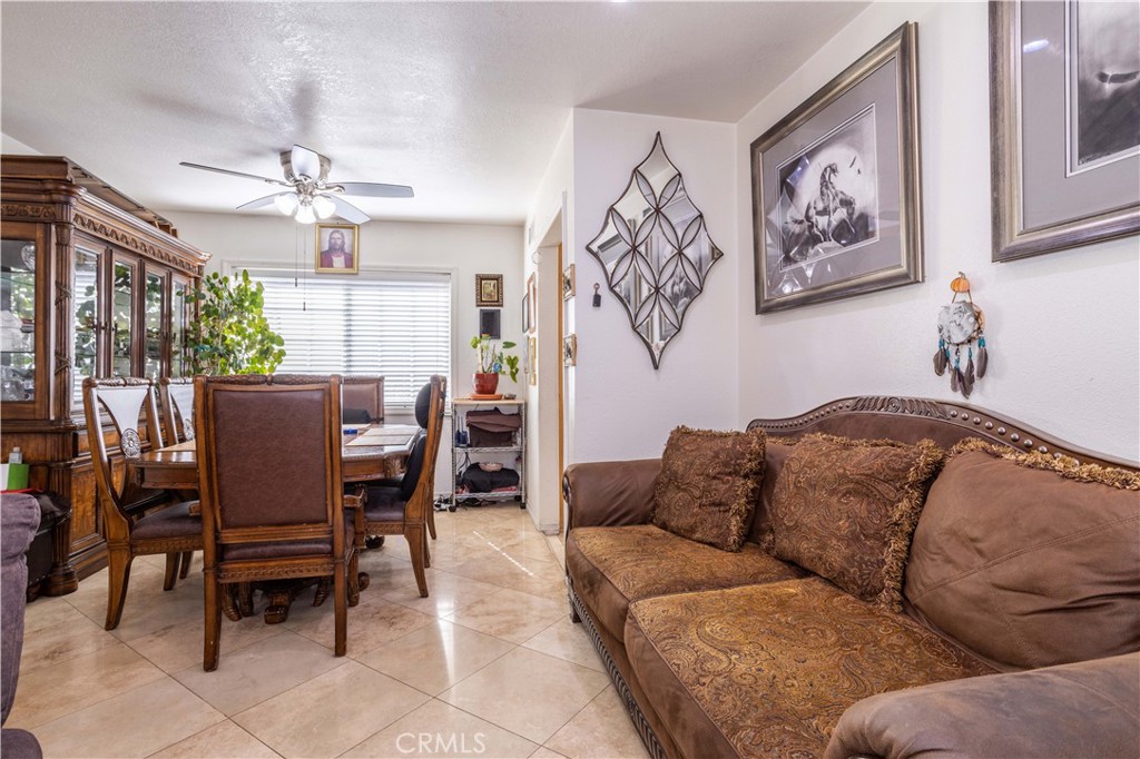 7414 Quartz Avenue Winnetka, CA 91306 - Photo 9 of 42 a living room with furniture a chandelier and a dining table