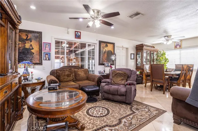 a living room with furniture a chandelier and a rug