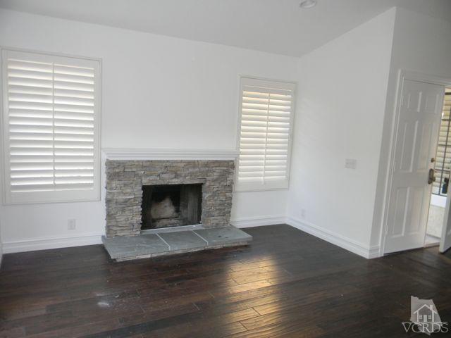 761 Congressional Road Simi Valley, CA 93065 - Photo 15 of 22 a living room with a fireplace and wooden floor