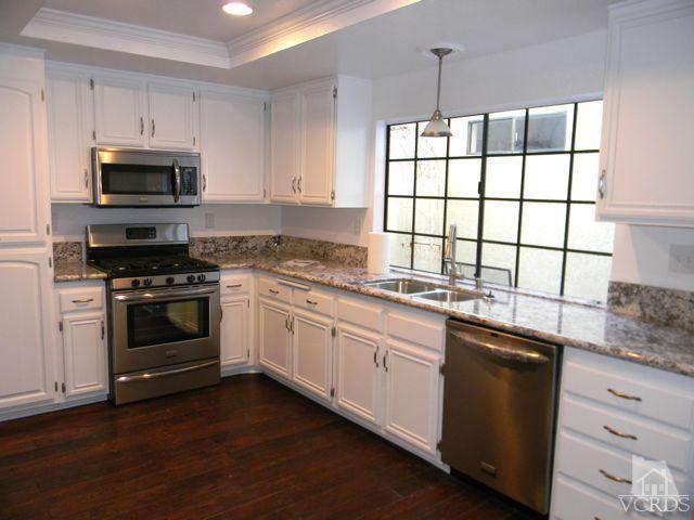 761 Congressional Road Simi Valley, CA 93065 - Photo 5 of 22 a kitchen with granite countertop white cabinets and white appliances