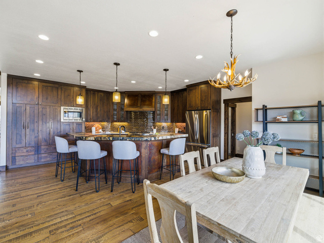 402 Shadow Hill Road Wanship, UT 84017 - Photo 18 of 90 Dining space with dark wood finished floors and hanging lights