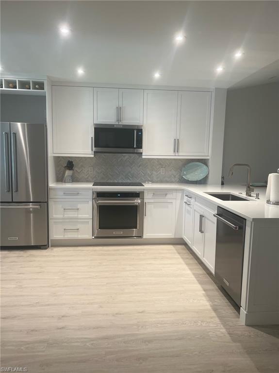 7713 Jewel Lane, Unit 202 Naples, FL 34109 - Photo 10 of 25 a kitchen with a sink stainless steel appliances and cabinets