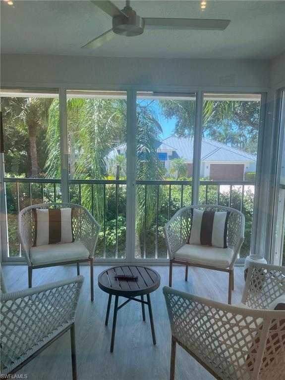 7713 Jewel Lane, Unit 202 Naples, FL 34109 - Photo 19 of 25 a living room with furniture and a large window