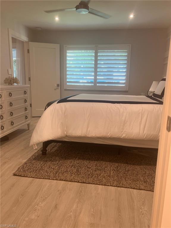 7713 Jewel Lane, Unit 202 Naples, FL 34109 - Photo 21 of 25 a bed sitting in a bedroom next to a window