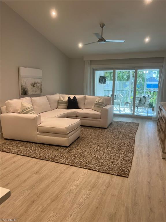 7713 Jewel Lane, Unit 202 Naples, FL 34109 - Photo 4 of 25 a living room with furniture and large windows