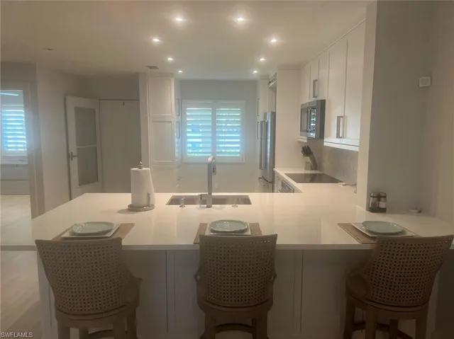 a living room with furniture and large windows