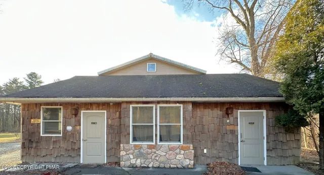 a front view of a house with large windows