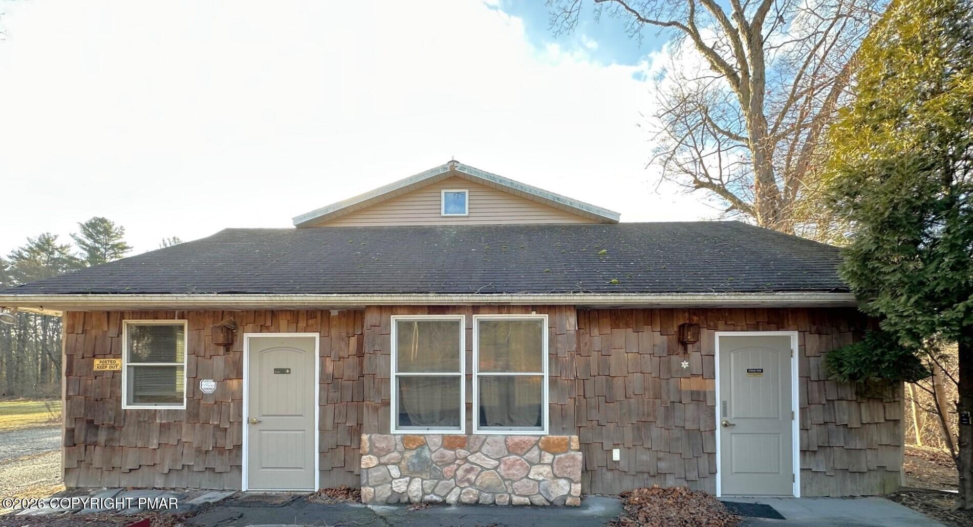 a front view of a house with large windows