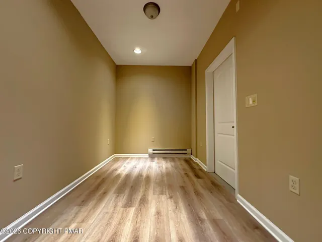a view of an empty room and wooden floor