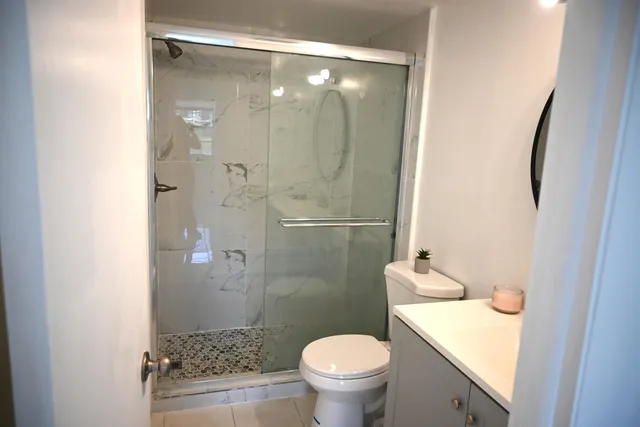 a bathroom with a sink mirror vanity and toilet