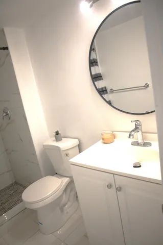 a bathroom with a sink toilet and shower