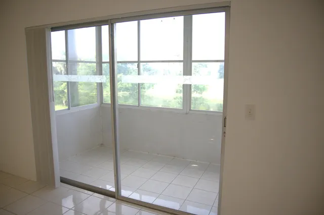 a view of a glass door with a yard from a window