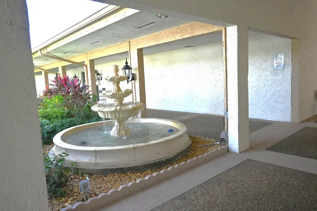 a view of a hallway with seating space