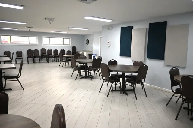 a living room with lots of furniture and view of kitchen