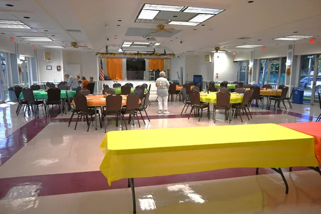 a living room with table and chairs