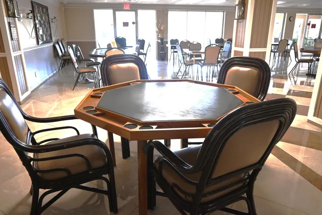 a dining room with furniture and floor to ceiling window