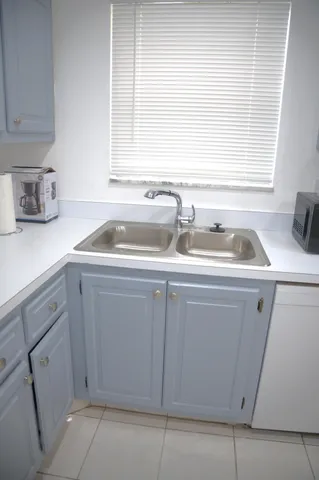 a kitchen with a sink and cabinets