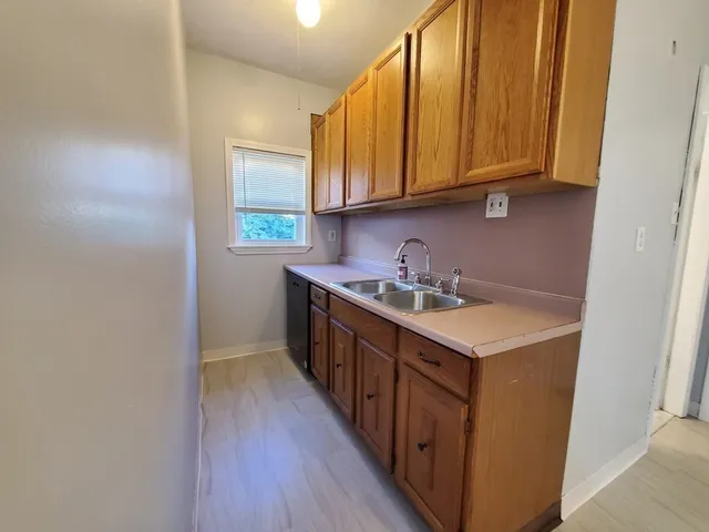 a kitchen with stainless steel appliances granite countertop a sink stove and cabinets