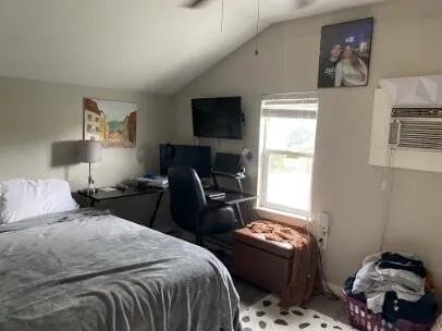 a bedroom with bed and a window