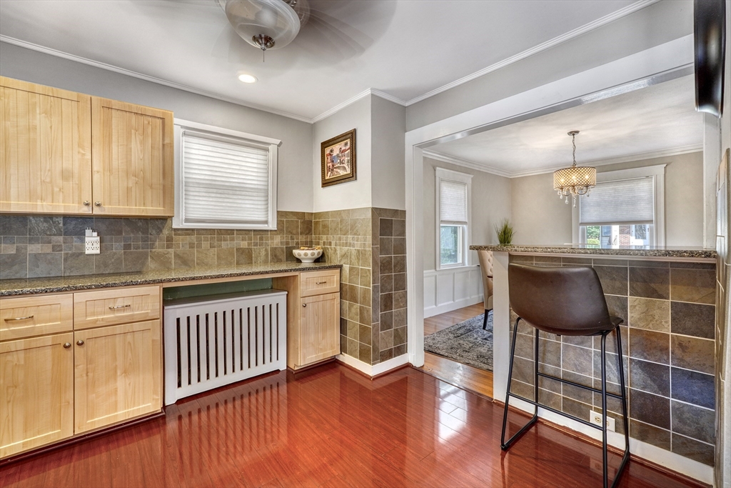 19 Gloria Road Boston, MA 02132 - Photo 14 of 42 a kitchen with stainless steel appliances granite countertop a stove a sink and white cabinets with wooden floor