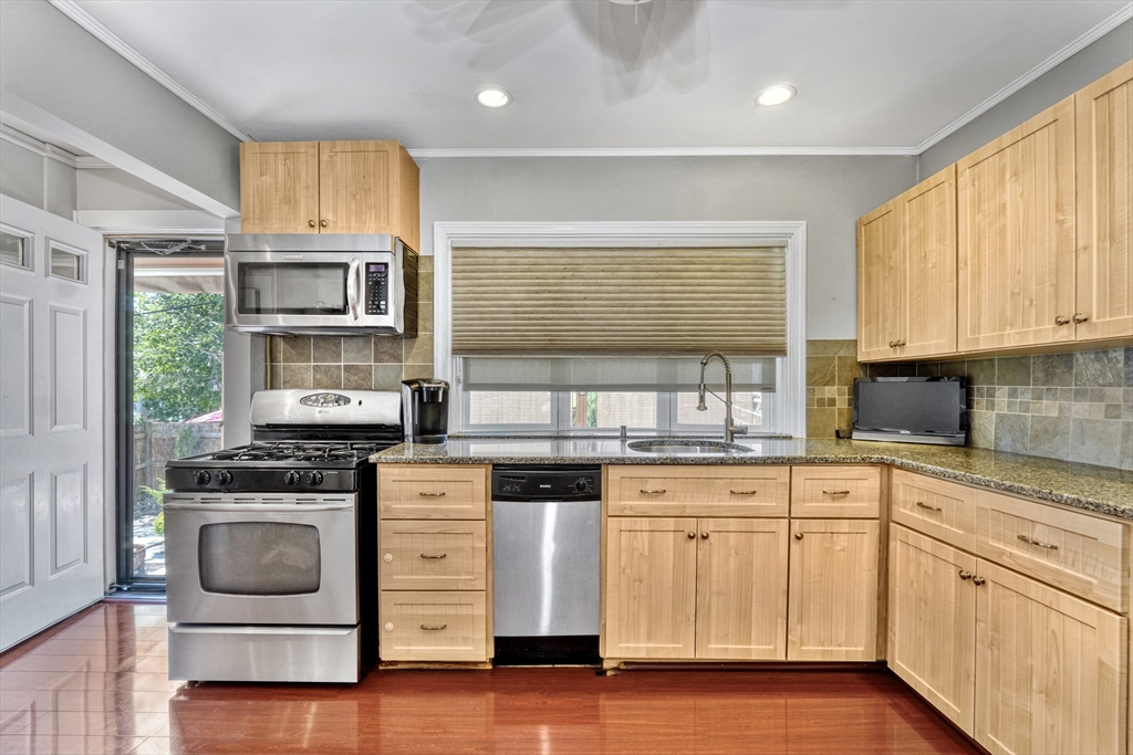 19 Gloria Road Boston, MA 02132 - Photo 15 of 42 a kitchen with stainless steel appliances granite countertop white cabinets sink and stove