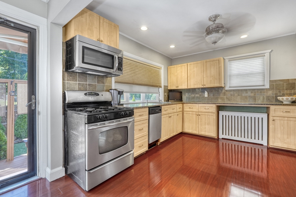 19 Gloria Road Boston, MA 02132 - Photo 16 of 42 a kitchen with stainless steel appliances granite countertop a stove a sink and a microwave