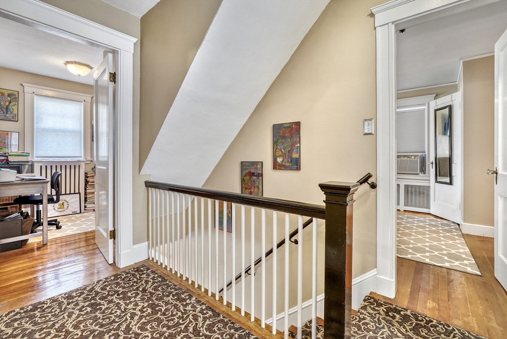 19 Gloria Road Boston, MA 02132 - Photo 19 of 42 a view of a hallway with wooden floor and staircase