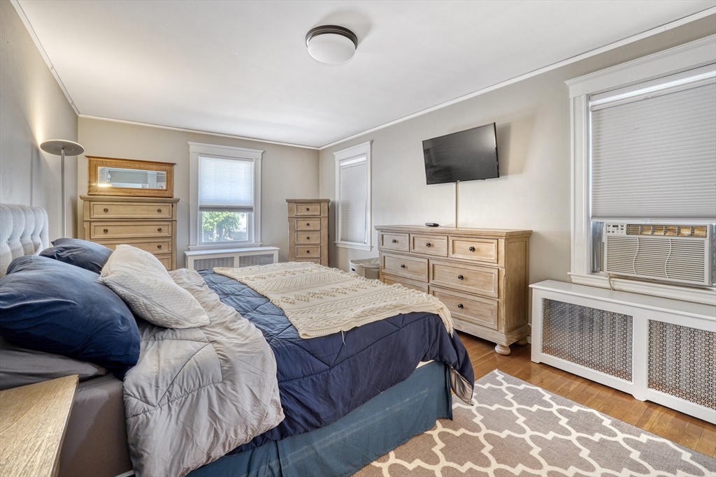 19 Gloria Road Boston, MA 02132 - Photo 20 of 42 a bedroom with a bed and flat screen tv