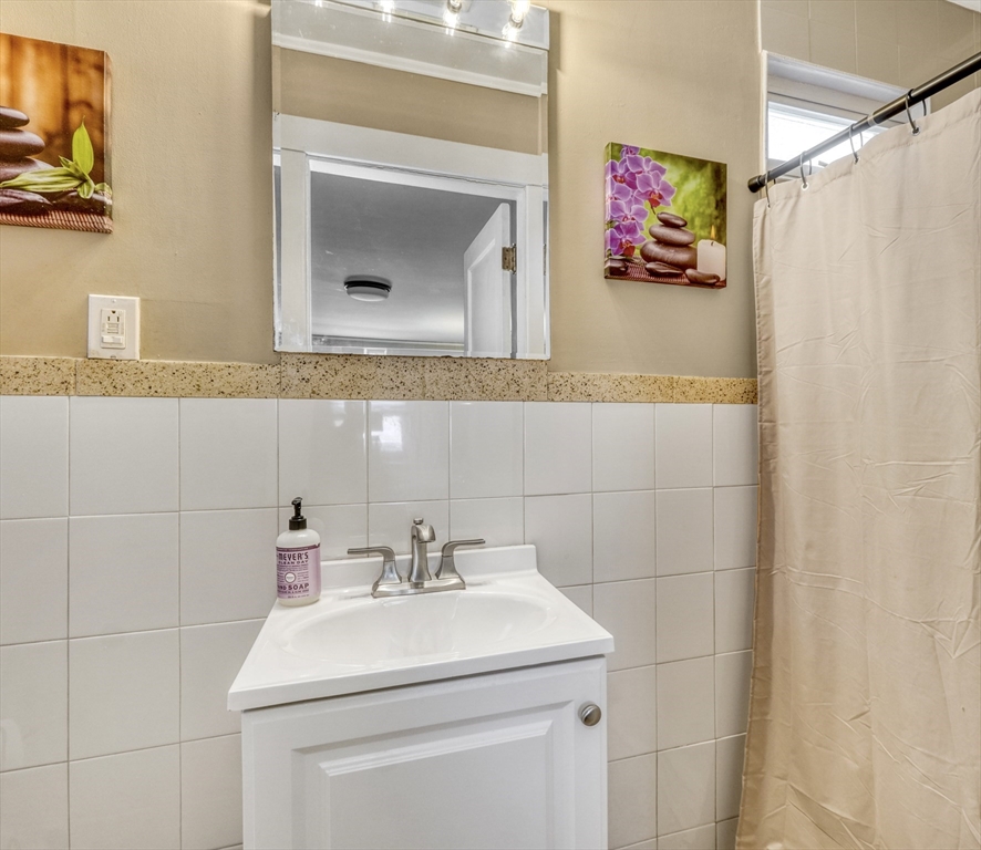 19 Gloria Road Boston, MA 02132 - Photo 22 of 42 a bathroom with a sink and a mirror