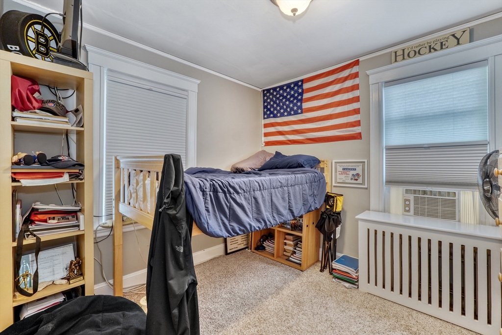 19 Gloria Road Boston, MA 02132 - Photo 24 of 42 a livingroom with furniture and a book shelf