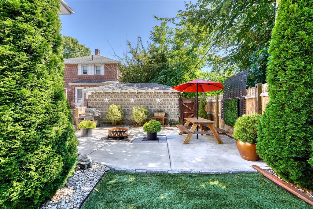 19 Gloria Road Boston, MA 02132 - Photo 33 of 42 an outdoor sitting area with chairs and table of the patio