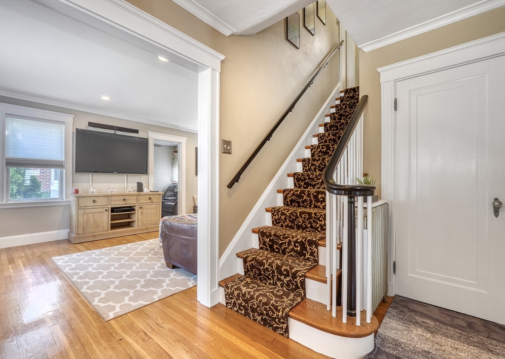 19 Gloria Road Boston, MA 02132 - Photo 5 of 42 a living room with fireplace furniture and a flat screen tv