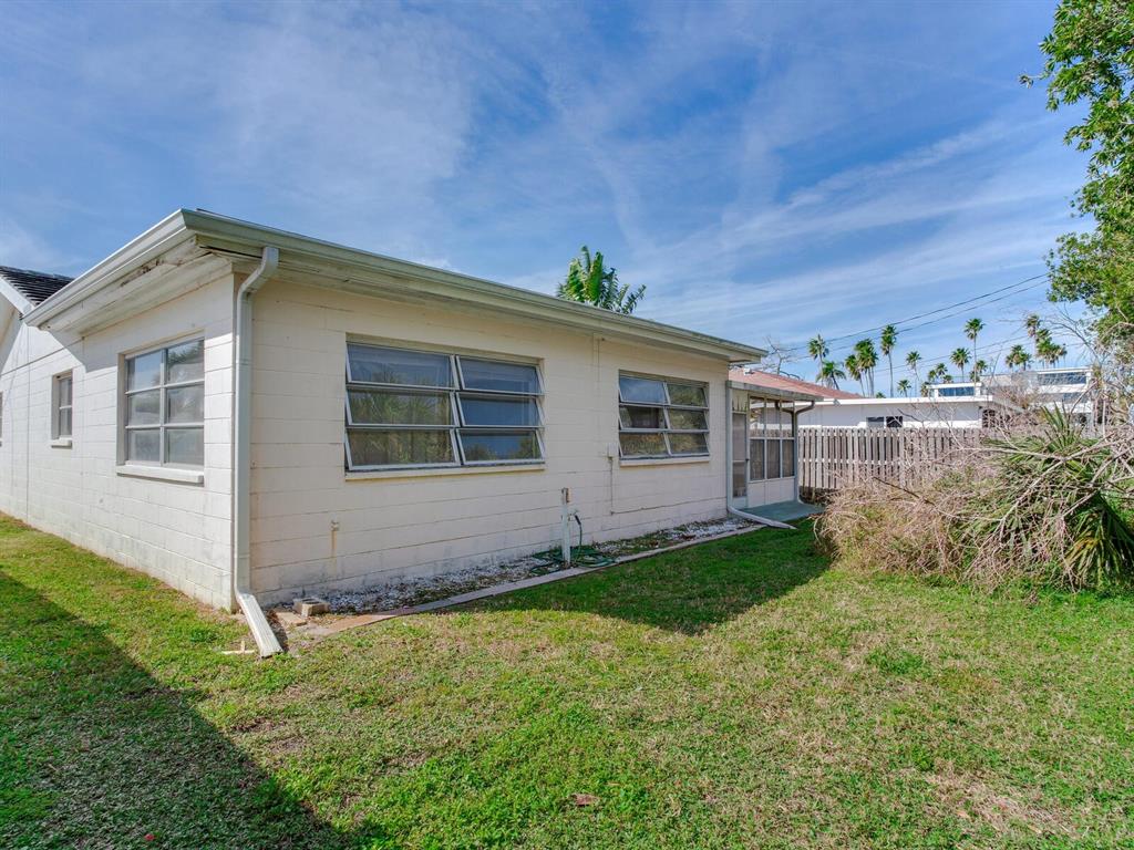 16105 1st Street East Redington Beach, FL 33708 - Photo 12 of 27 a backyard of a house with lots of green space