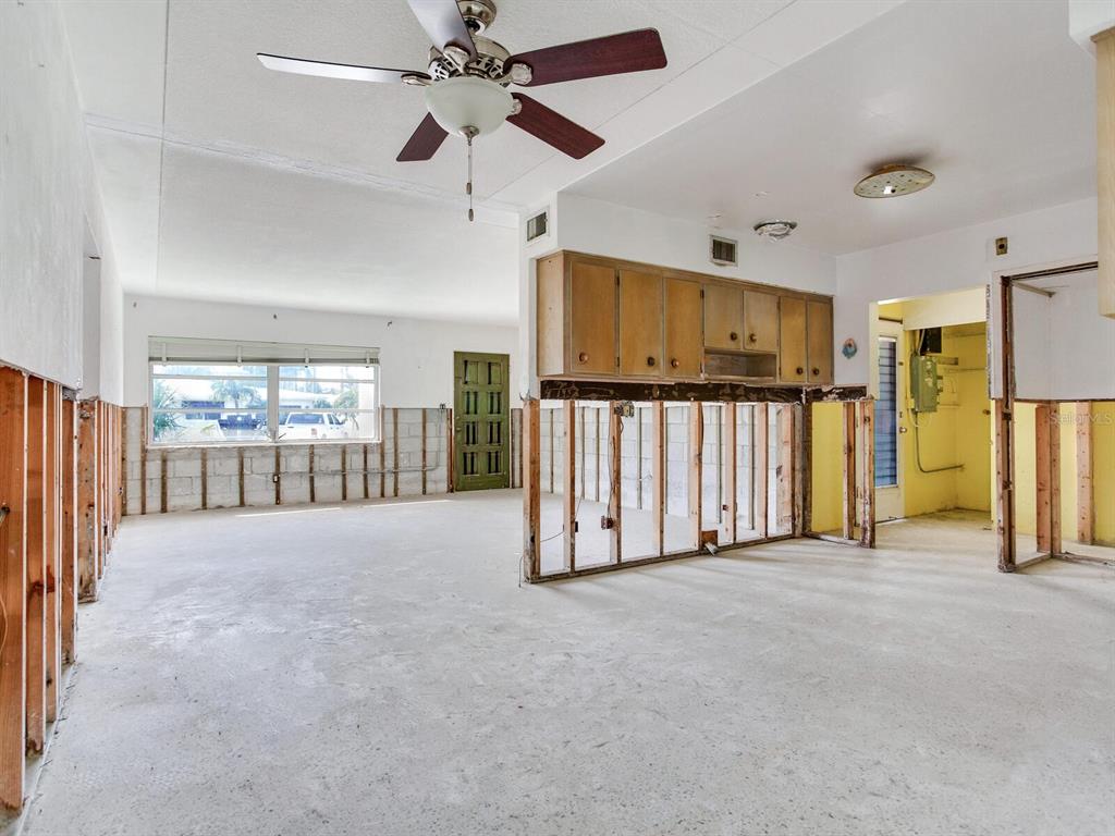 16105 1st Street East Redington Beach, FL 33708 - Photo 17 of 27 a view of a livingroom with closet area stairs and a window